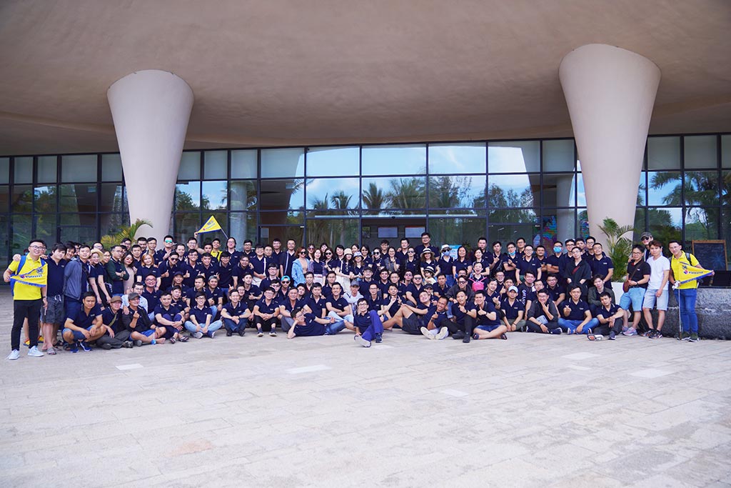 A large group of people in yellow shirts posing for a photo

Description automatically generated with low confidence